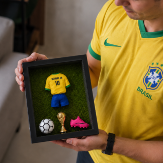 Férfi kezében a Legends Box kézzel készített focis emlékdoboz, Neymar Jr. 10-es Brasil mezzel, labdával, kupával és cipővel
